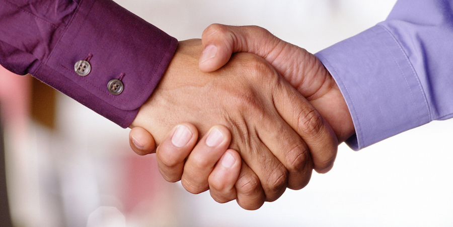 Closeup of two hands shaking.