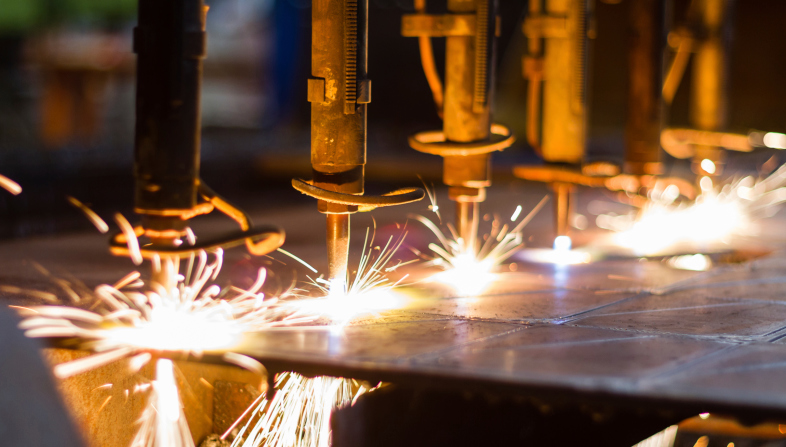 Steel being cut by multi-head plasma cutter.
