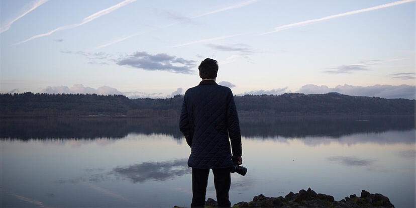 Man-looking-out-at-lake