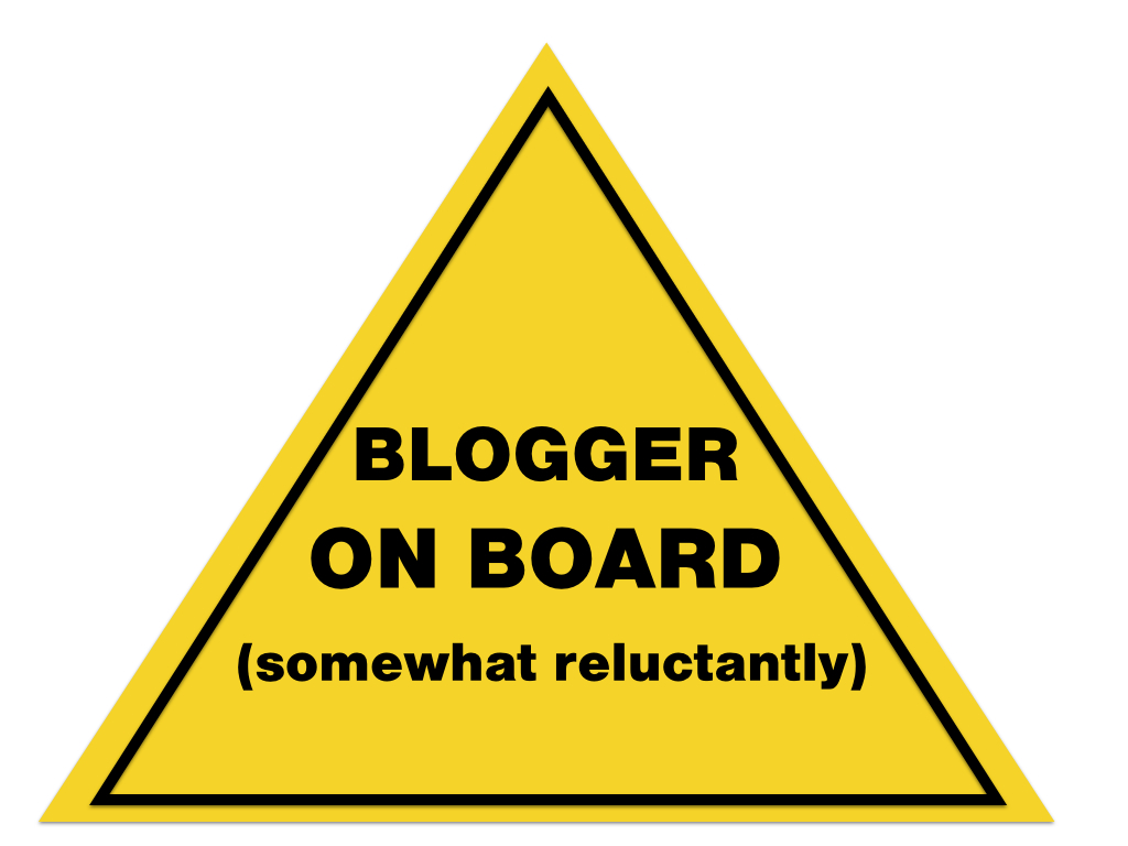 Warning sign that says blogger on board (somewhat reluctantly)