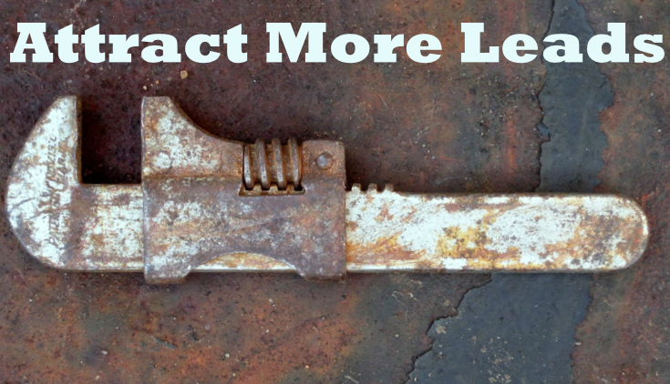 Rusty adjustable wrench laying on concrete. The words attract more leads are above it.