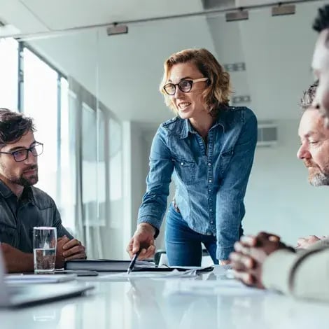 woman-standing-at-table-in-meeting-room