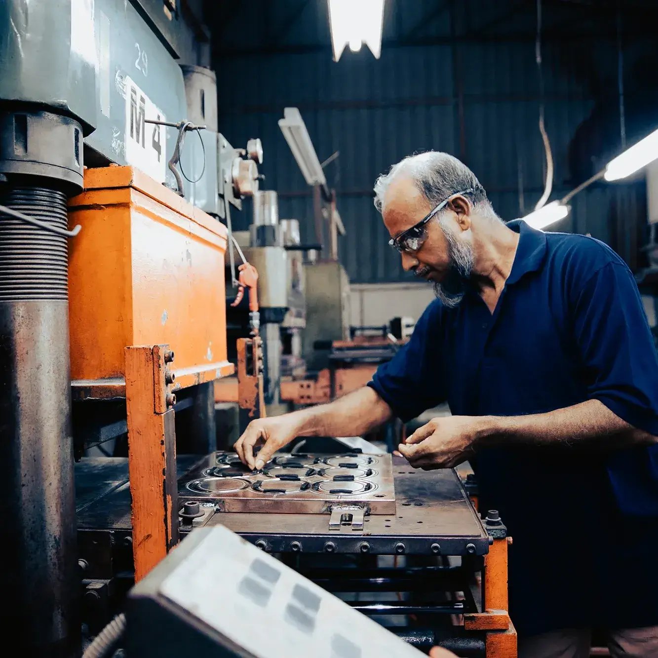 guy_at_machine_in_shop