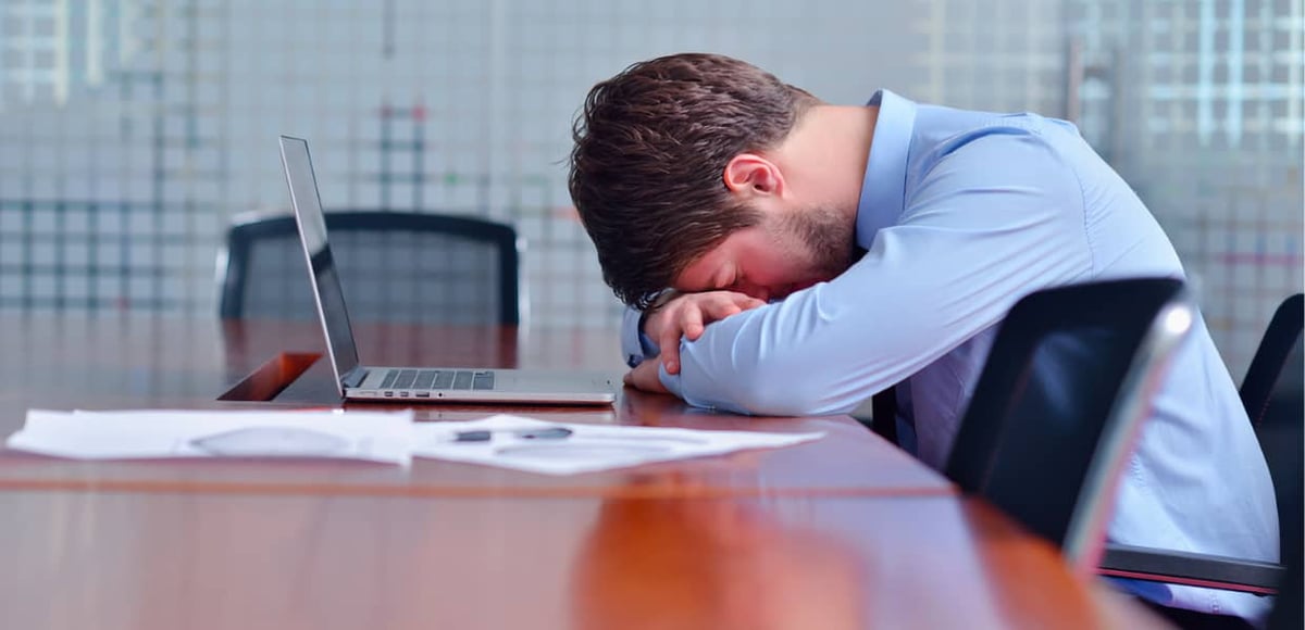 Person in conference with head on table