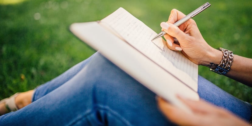 Woman-writing-in-park