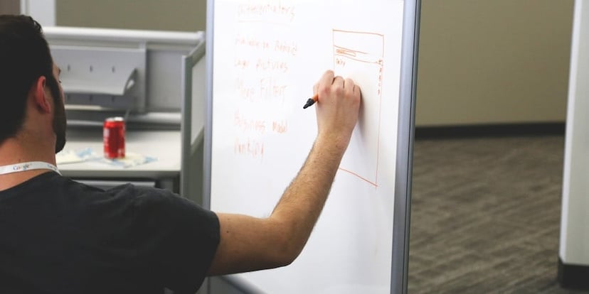 man-drawing-on-whiteboard 