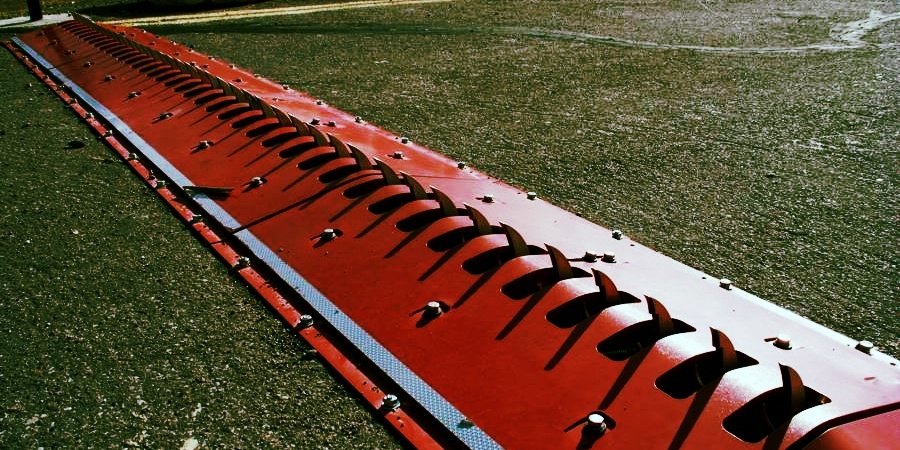 Backup traffic spikes on a asphalt road.
