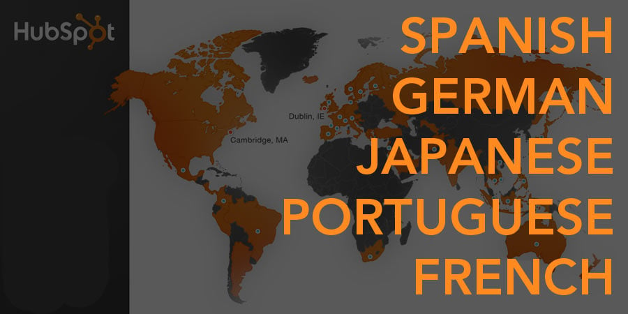 The words Spanish, German, Japanese, Portuguese, and French overlay a world map with some countries in orange and others in grey. Cambridge, MA and Dublin, IE are pointed out. 