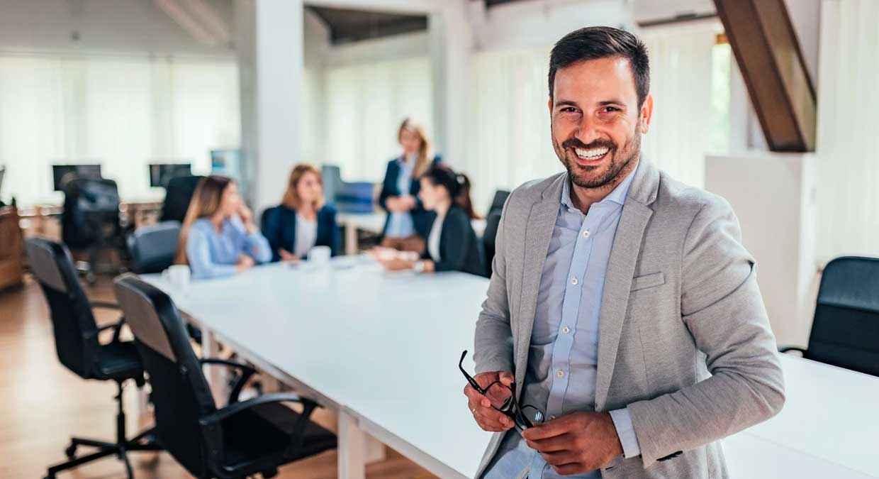 man_smiling_in_conference_room