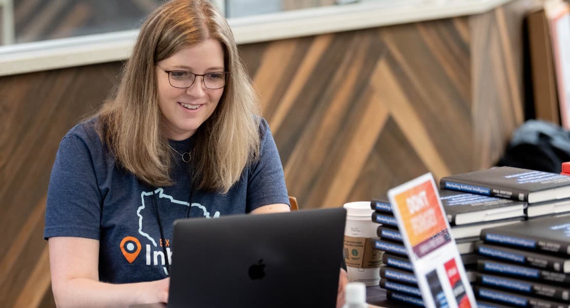 Weidert employee on latptop at event