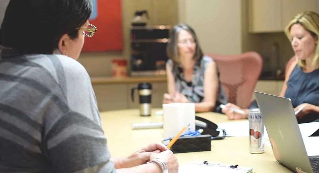 Key account executives sitting around a conference room table at Weidert Group