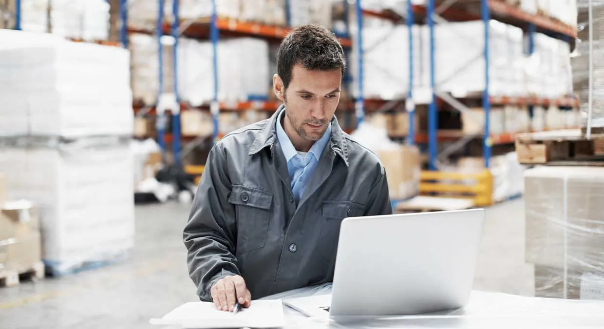 supervisor_on_plant_floor_laptop_reviewing_analytics