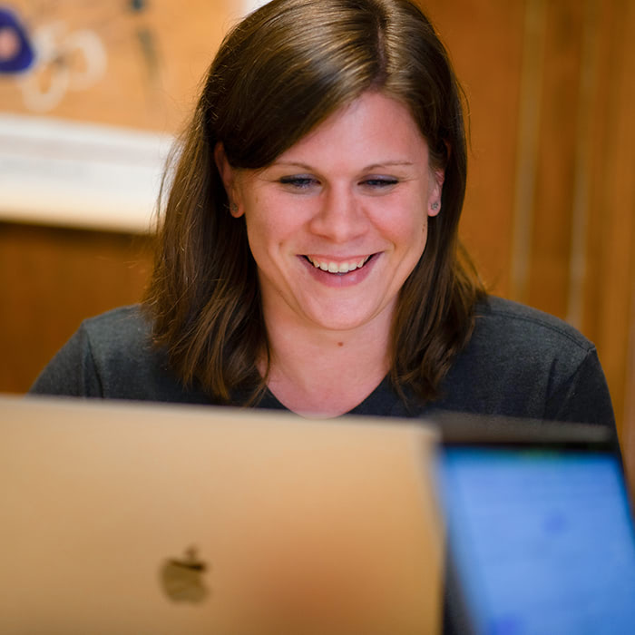 weidert woman smiling working on laptop-